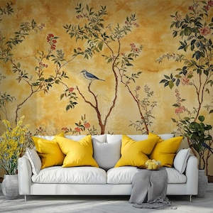 May include: A white sofa with yellow throw cushions sits in front of a wall mural featuring a yellow background with a stylised floral design and a blue bird perched on a branch.
