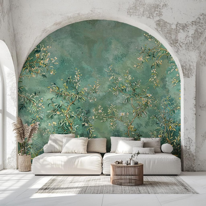 May include: A white sofa with two cushions and a throw pillow sits in front of a wall mural featuring a green background with white flowers and leaves.
