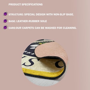 May include: A round rug with a non-slip rubber base, displaying a design with the letter "S" and a yellow border. The rug has a leather-rubber sole and is washable. The text "RUBBER (NON-SLIP) BASE" is at the top.