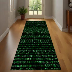 May include: A rectangular black rug with a binary code pattern in bright green, placed in a hallway with wooden floors. The rug's design features a repeating sequence of 0s and 1s.