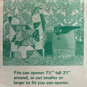 May include: A green and white patchwork fabric bird with a black eye, next to a black can opener. The text reads: "Fits can opener 7 1/2" tall 21" around, or cut smaller or larger to fit you can opener."