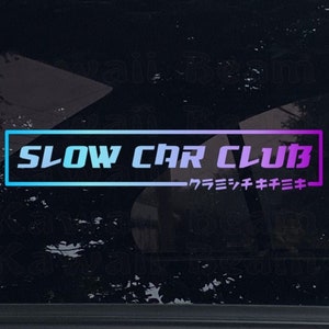 May include: A sticker with a blue and purple gradient border and the text "SLOW CAR CLUB" in white. The text "ワラモシキキキ" is in purple below the main text.
