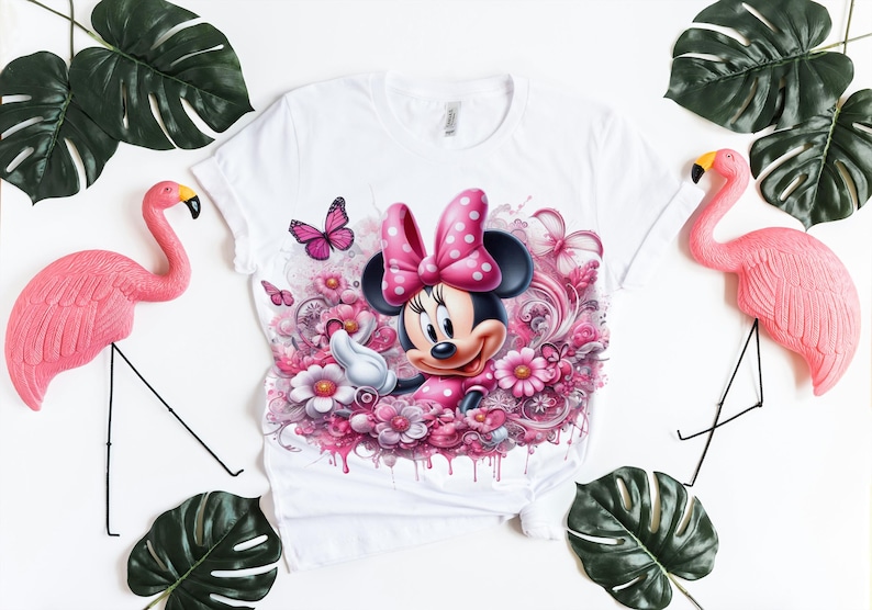 May include: White t-shirt with a pink and white cartoon image of Minnie Mouse surrounded by pink flowers.