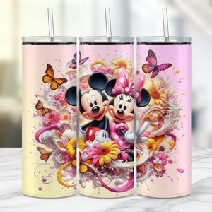 May include: Three stainless steel tumblers with a colorful design featuring Mickey and Minnie Mouse surrounded by flowers and butterflies. Each tumbler has a straw and a gradient background of yellow and pink.