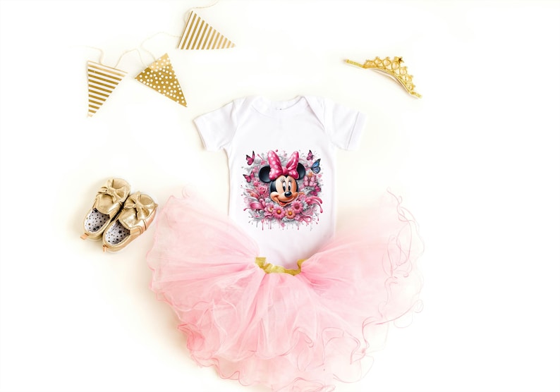 May include: A white bodysuit with a pink and black Minnie Mouse graphic, a pink tulle tutu, and gold shoes. The bodysuit has a watercolor-style design with flowers and butterflies.