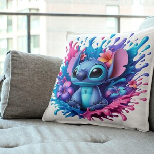 May include: A white throw pillow with a colorful design featuring Stitch from Lilo & Stitch. Stitch is surrounded by pink, blue, and purple paint splatters and tropical flowers.