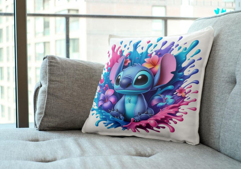 May include: A white throw pillow with a colorful design featuring Stitch from Lilo & Stitch. Stitch is surrounded by pink, blue, and purple paint splatters and tropical flowers.
