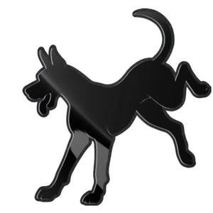 May include: A glossy black silhouette of a dog in mid-stride, with its tail curved upwards. The dog's form is stylized, with clean lines and a smooth, reflective surface. The image is set against a plain white background.