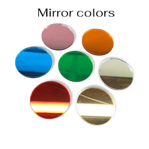 May include: A collection of seven circular mirror pieces in various colors, including blue, green, red, gold, orange, silver, and pink. The text "Mirror colors" is displayed above the mirrors.