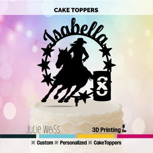 May include: Black cake topper featuring a silhouette of a person riding a horse around a barrel, with the name "Isabella" above. The design includes stars and the number "8". The words "Cake Toppers", "Julie Weiss", and "3D Printing" are also visible.
