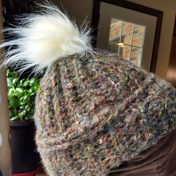 Hand crocheted soft wool stocking cap with faux rabbit pom on top.