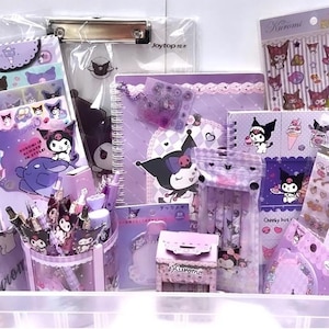 May include: A collection of purple and black stationery items featuring the character Kuromi from the Sanrio franchise. The items include stickers, pens, notebooks, and a pencil holder. The items are all decorated with Kuromi's signature skull and crossbones design.