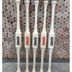 May include: Five wooden baseball bats with black and red accents. The bats are all the same size and have the word "SabreCat" printed on them in red.