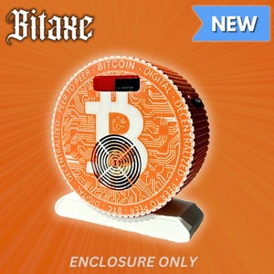 May include: Orange and white Bitcoin mining enclosure with a fan and a Bitcoin logo. The enclosure is labeled "Bitaxe" and "NEW".