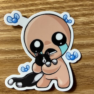 May include: A sticker featuring a cartoon character with a bald head, large black eyes, and a tear. The character is hugging a black and white cat. Blue bow-shaped accents are on the sticker.