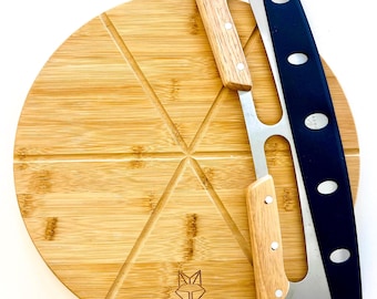 May include: A round bamboo pizza cutting board with a built-in pizza cutter. The board is divided into six slices and has the word "KOBIVA" printed on the bottom. The pizza cutter has a black handle and a stainless steel blade.