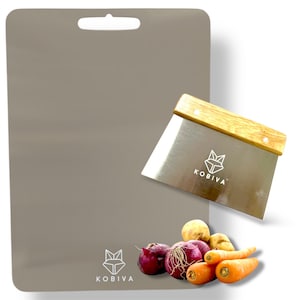 May include: A gray cutting board with a handle and a stainless steel scraper with a wooden handle. The scraper and board have the "KOBIVA" logo. Red onions, carrots, and potatoes are in the foreground.