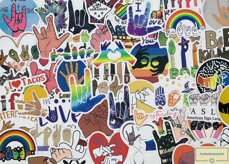May include: A collection of colourful stickers featuring various hand signs in American Sign Language (ASL). The stickers are on a white background and include phrases like "I love you", "Be Kind", "ASL", and "American Sign Language".