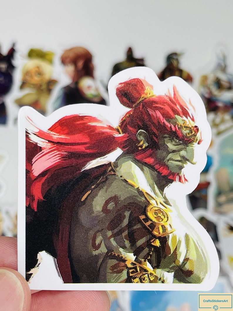 May include: A sticker featuring a detailed illustration of a red-haired, green-skinned character with a golden crown and armour. The character has a fierce expression and is depicted in a dynamic pose.