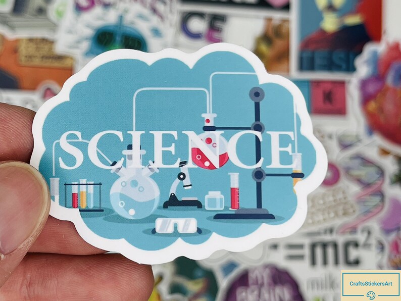 May include: A blue and white sticker with a cartoon illustration of a science lab. The sticker says "SCIENCE" in white letters. The lab includes beakers, test tubes, a microscope, and a stand with a flask.