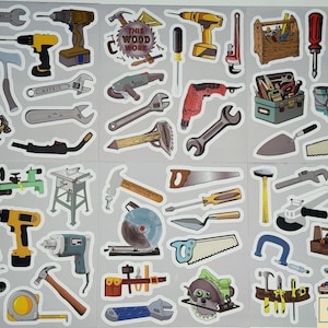 May include: A collection of tool stickers featuring various hand tools and power tools. The stickers include wrenches, drills, saws, hammers, and toolboxes. The text "THIS WOOD WORK" is visible on one of the stickers. The stickers are on a gray background.