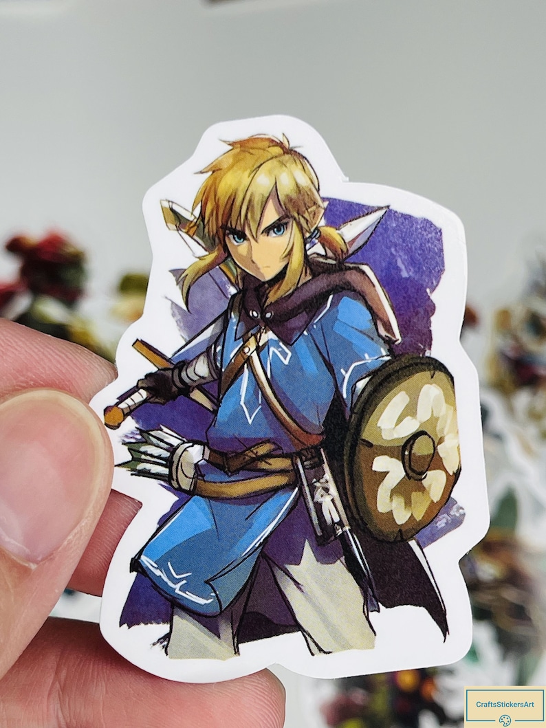 May include: A sticker featuring a cartoon illustration of Link from the Legend of Zelda video game series. Link is wearing a blue tunic, brown trousers, and a green cap. He is holding a sword and shield. The background is a purple watercolour wash.