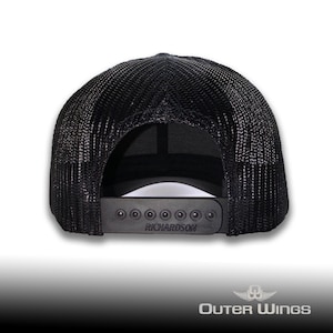 May include: Black trucker hat with a mesh back and a curved brim. The adjustable snap closure features the brand name "RICHARDSON". The hat is designed with a classic, casual style.