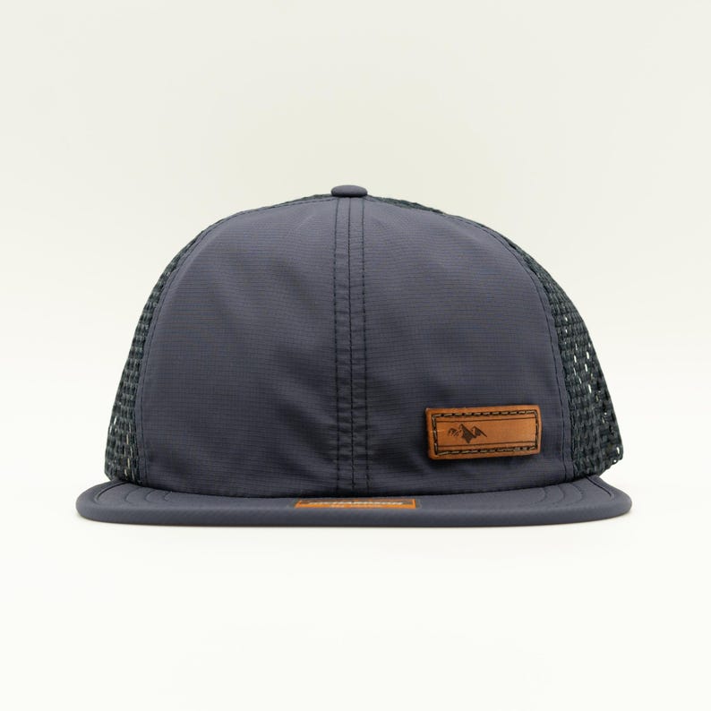 Front view of navy Richardson 935 water resistant performance hat with full grain leather Active Mountain patch, mesh back and quick-adjust strap, everyday outdoors hat