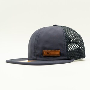 Side view of navy Richardson 935 performance hat with dark mesh back and leather Active Mountain patch, water resistant leather patch hat for active mountain lifestyles