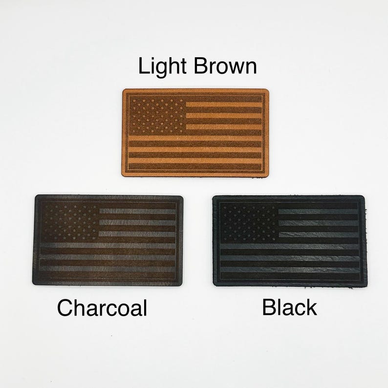 May include: Three rectangular patches featuring the American flag design. The patches are in light brown, charcoal, and black. The text "Light Brown", "Charcoal", and "Black" are printed below each patch.