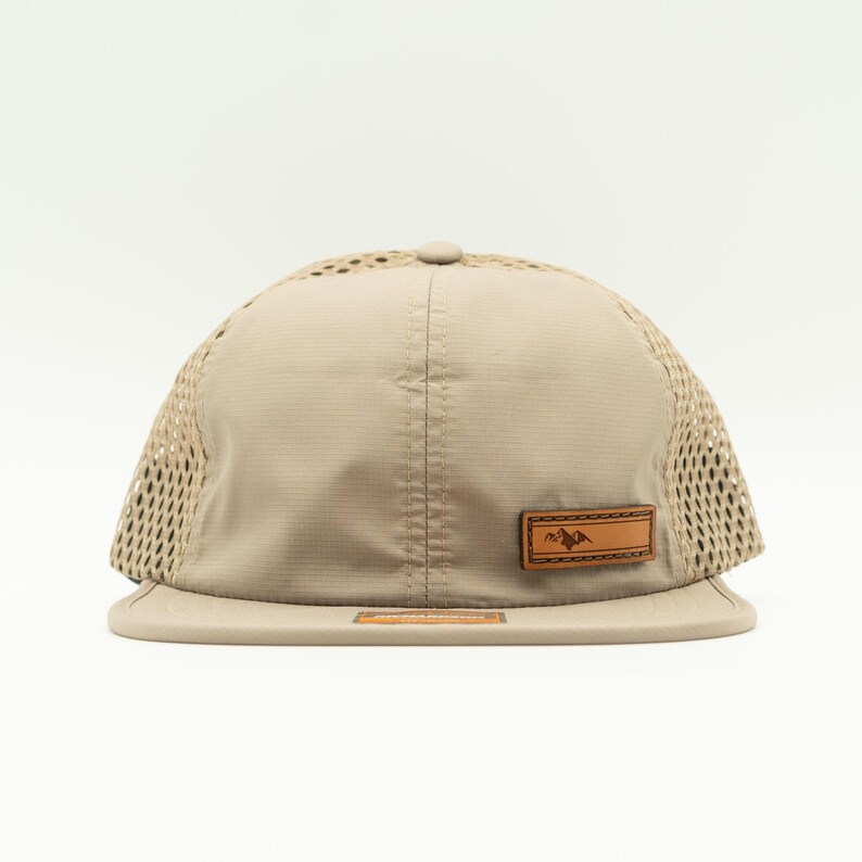 Front view of sand Richardson 935 performance outdoors hat with real leather Active Mountain patch, curved bill and breathable mesh, water resistant leather patch hat for hiking and travel