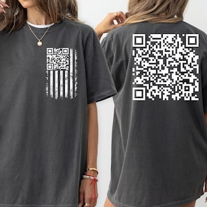 May include: A dark gray oversized t-shirt with a white QR code printed on the back and a white QR code with an American flag design printed on the front.