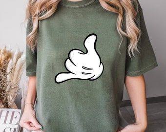 May include: A green t-shirt with a white cartoon hand making a call me gesture.