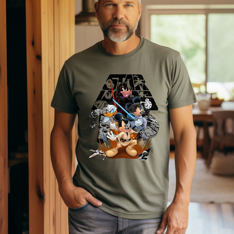 May include: A green t-shirt with a graphic print of Mickey Mouse, Donald Duck, and Minnie Mouse dressed as Star Wars characters. The text "Star Wars" is printed above the characters.