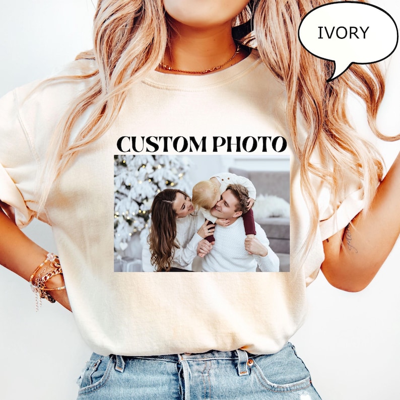 May include: Ivory-colored sweatshirt with the words "CUSTOM PHOTO" printed in black. The sweatshirt features a framed photograph of a family. The word "IVORY" is in a speech bubble.
