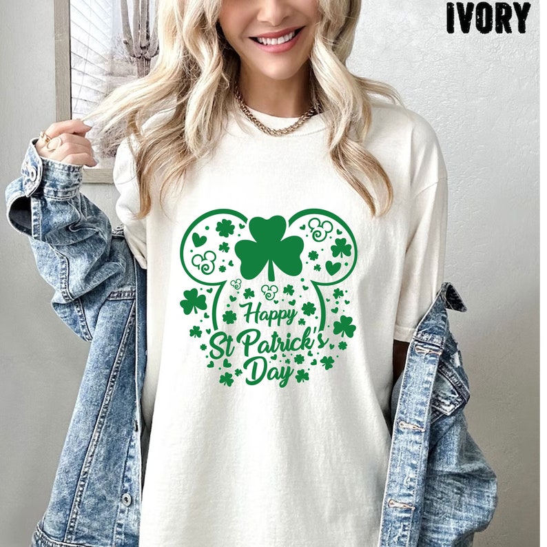 May include: White t-shirt with a green shamrock and the text "Happy St. Patrick's Day" in a Mickey Mouse head shape.