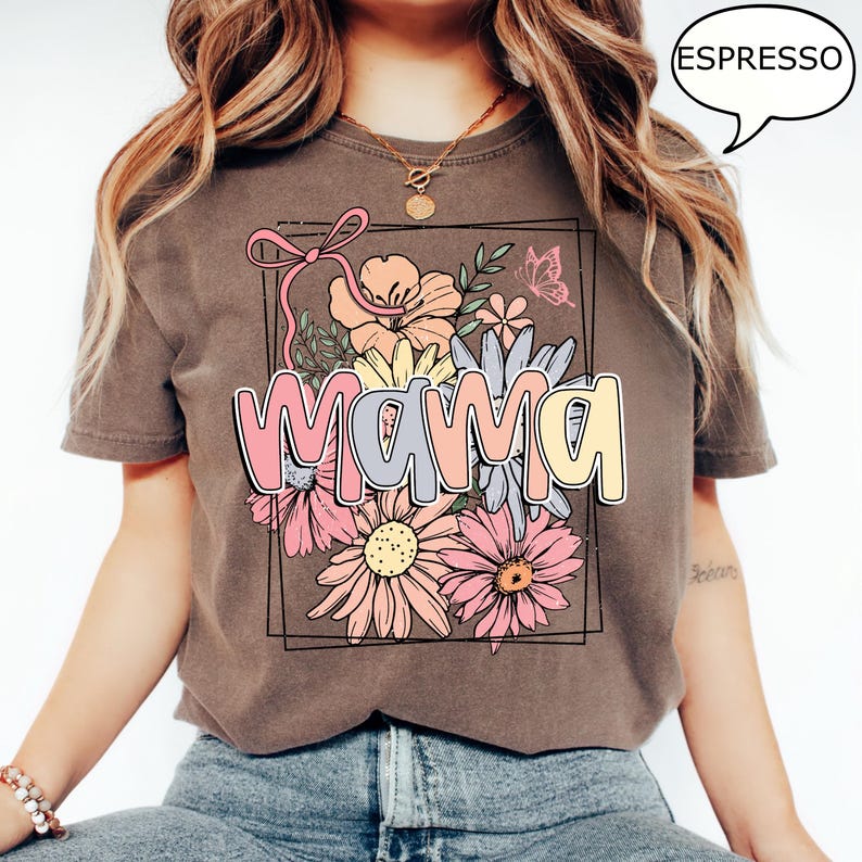 May include: A brown t-shirt with a floral design and the word "mama" in pastel colors. The design is framed in a rectangle.