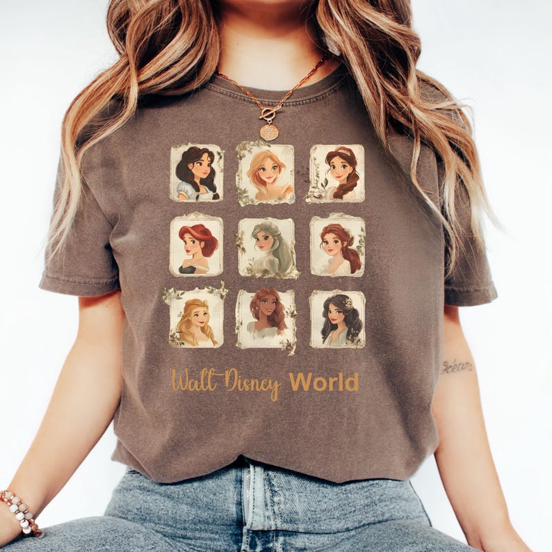 May include: A brown t-shirt with a graphic of nine Disney princesses in vintage frames. The text "Walt Disney World" is printed below the frames.
