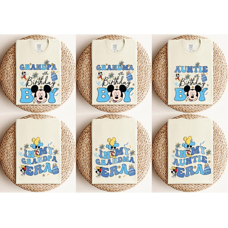 May include: Six white t-shirts with blue and yellow designs featuring Mickey Mouse. The shirts have text that reads "In My Grandpa Era", "In My Grandma Era", "In My Auntie Era", "Grandpa of the Birthday Boy", "Grandma of the Birthday Boy", and "Auntie of the Birthday Boy".