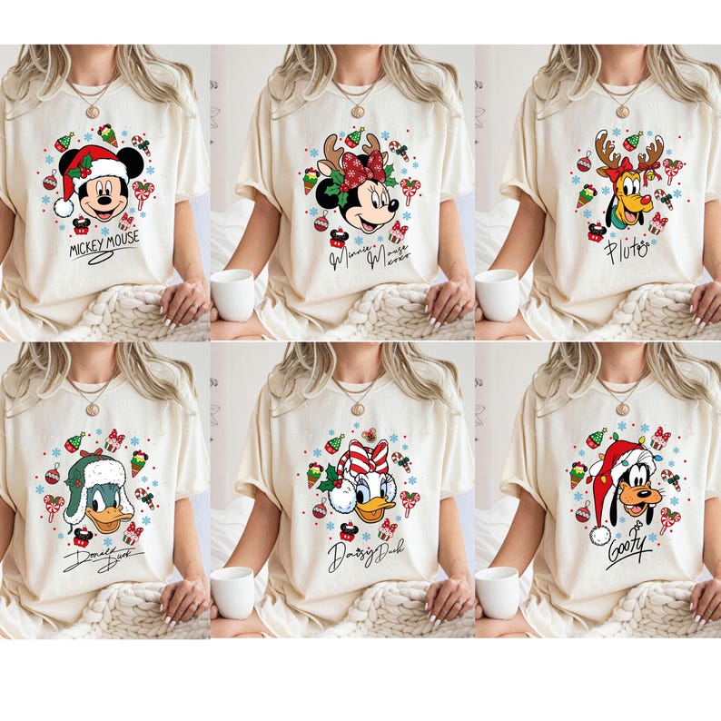 May include: Six cream-colored t-shirts featuring Disney characters in festive Christmas designs. Each shirt showcases a different character: Mickey Mouse, Minnie Mouse, Pluto, Donald Duck, Daisy Duck, and Goofy, all wearing holiday attire. Each shirt has the character's name.