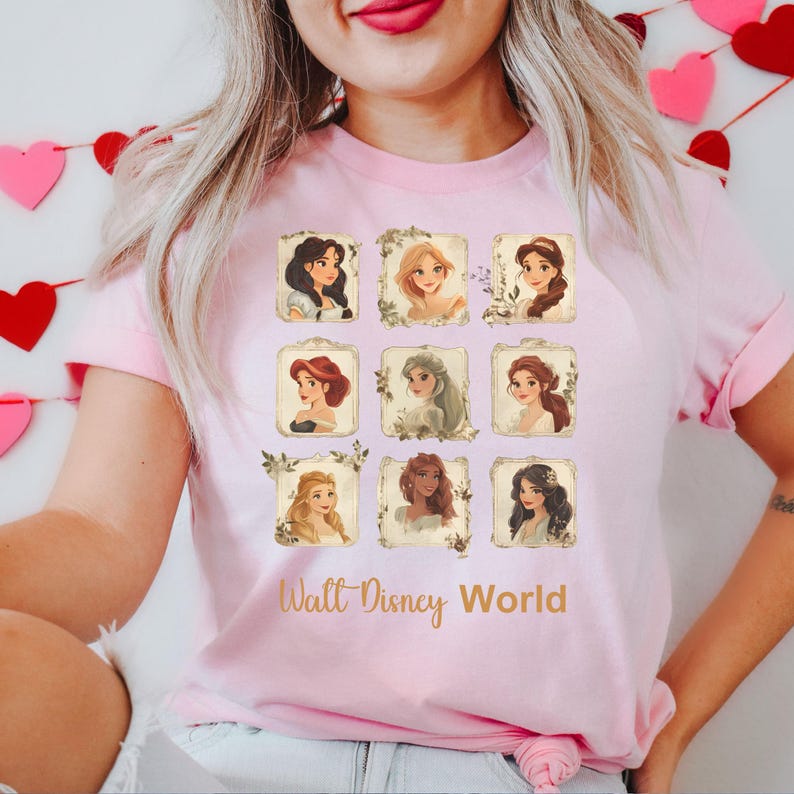 May include: Pink t-shirt with a graphic of nine Disney princesses in frames with floral accents. The text "Walt Disney World" is printed below the images.