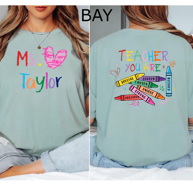 May include: A light green t-shirt with colorful text and graphics. The front features "Ms. Taylor" with a heart. The back says "Teacher You Are" with crayon illustrations and positive words. A cute and colorful design.