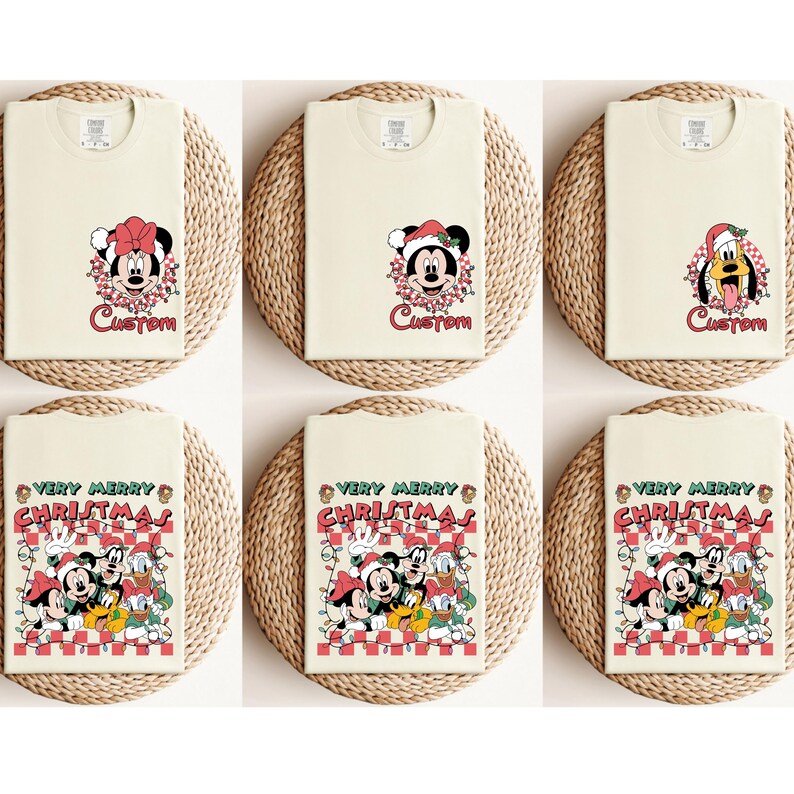 May include: Cream-colored t-shirts with holiday-themed graphics. Designs include Mickey and Minnie Mouse, Mickey Mouse, and Pluto wearing Santa hats, and a group graphic with Mickey, Minnie, Donald, and Goofy. Each shirt has the word "Custom" or "Very Merry Christmas".