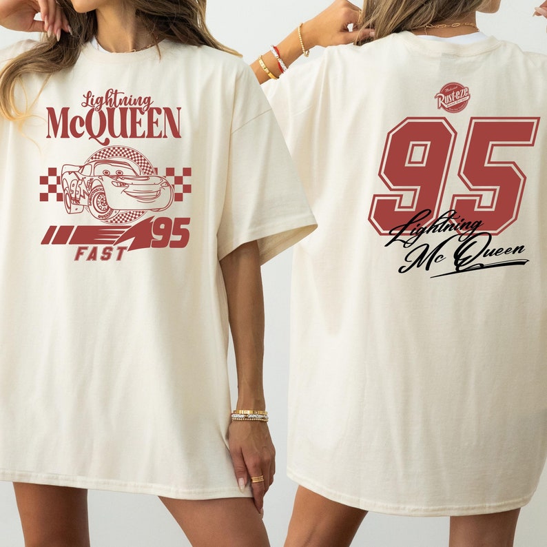 May include: A white oversized t-shirt with a red graphic of Lightning McQueen from the Cars movie. The front of the shirt features the car, the number 95, and the words "Lightning McQueen" and "Fast". The back of the shirt features the number 95, the words "Lightning McQueen", and a red circle with the word "Rust-eze" inside.