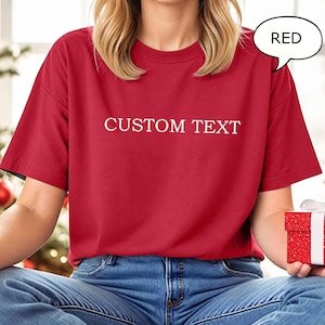 May include: A red t-shirt with the text "CUSTOM TEXT" printed in white on the front.
