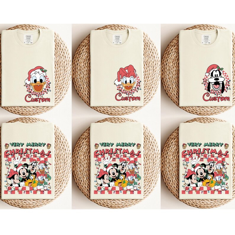 May include: Six cream-colored t-shirts with Christmas-themed graphics. The top row features Donald Duck and Goofy in Santa hats with the word "Custom". The bottom row displays Mickey, Minnie, Donald, and Goofy with the text "Very Merry Christmas".