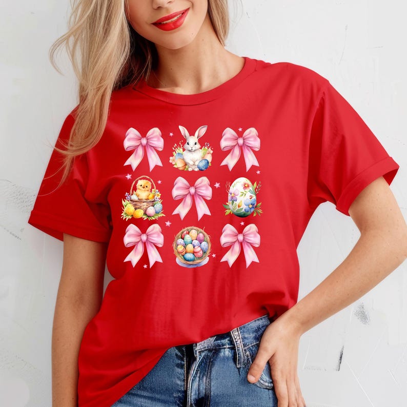 Puede incluir: Camiseta roja con un gr&aacute;fico de lazos rosas, un conejito, un pollito y huevos de Pascua.
