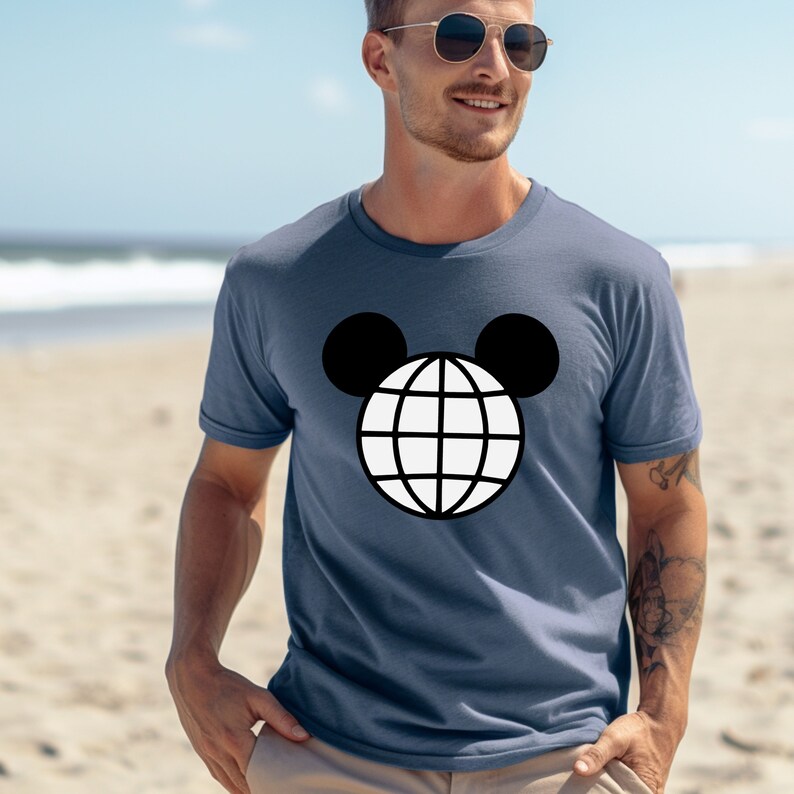 K&ouml;nnte beinhalten: Ein marineblaues T-Shirt mit einem wei&szlig;en Globus-Motiv in schwarzen Mickey-Maus-Ohren.
