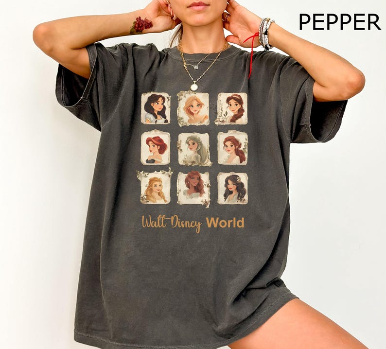 May include: A dark gray t-shirt with a graphic print of Disney princesses in a grid pattern. The text "Walt Disney World" is printed below the grid.