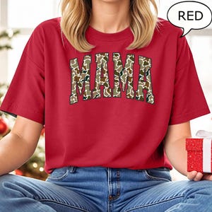 May include: Red t-shirt with a camo print "MAMA" graphic.